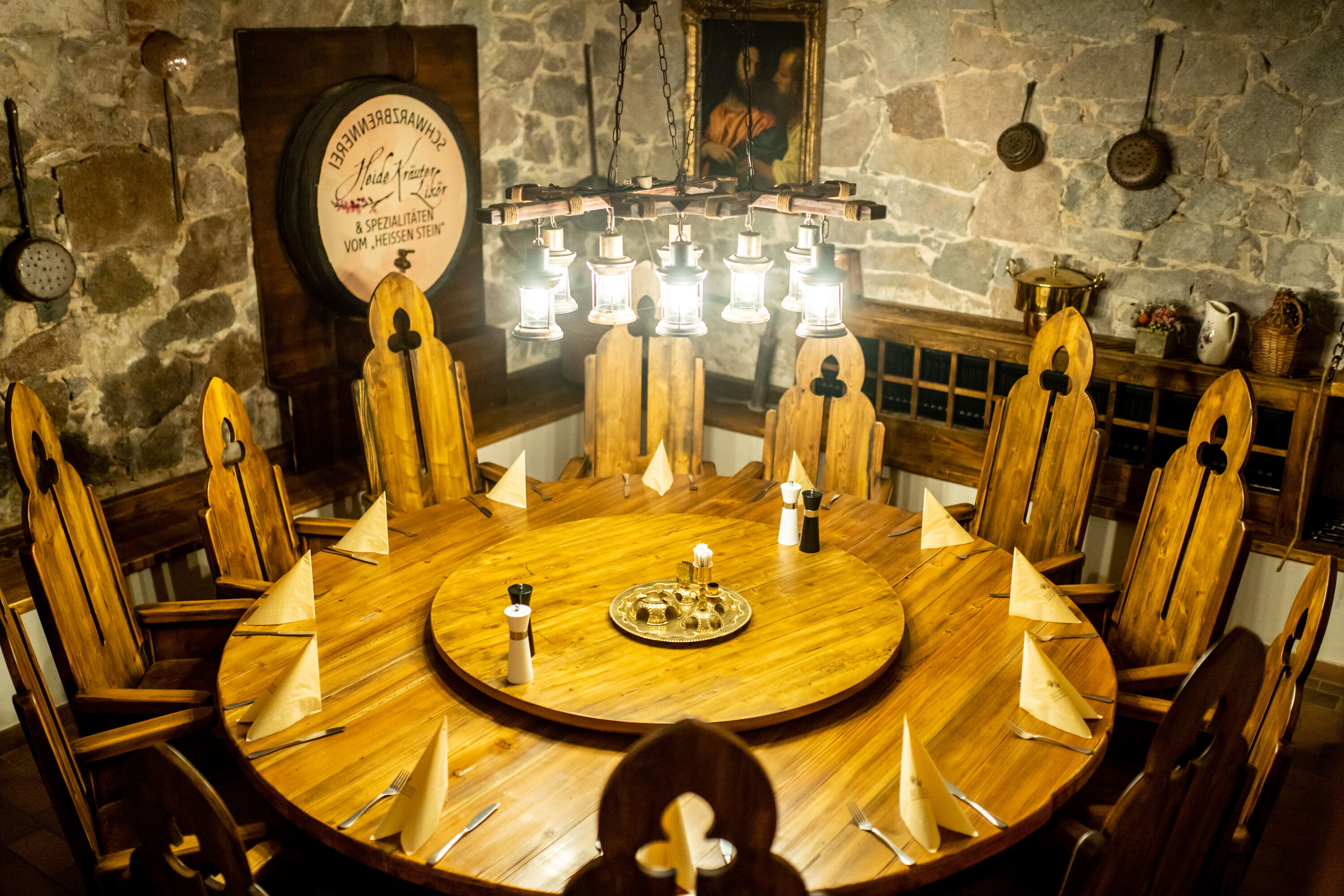Rustic round dining table in cellar vault Rustic round dining table in cellar vault